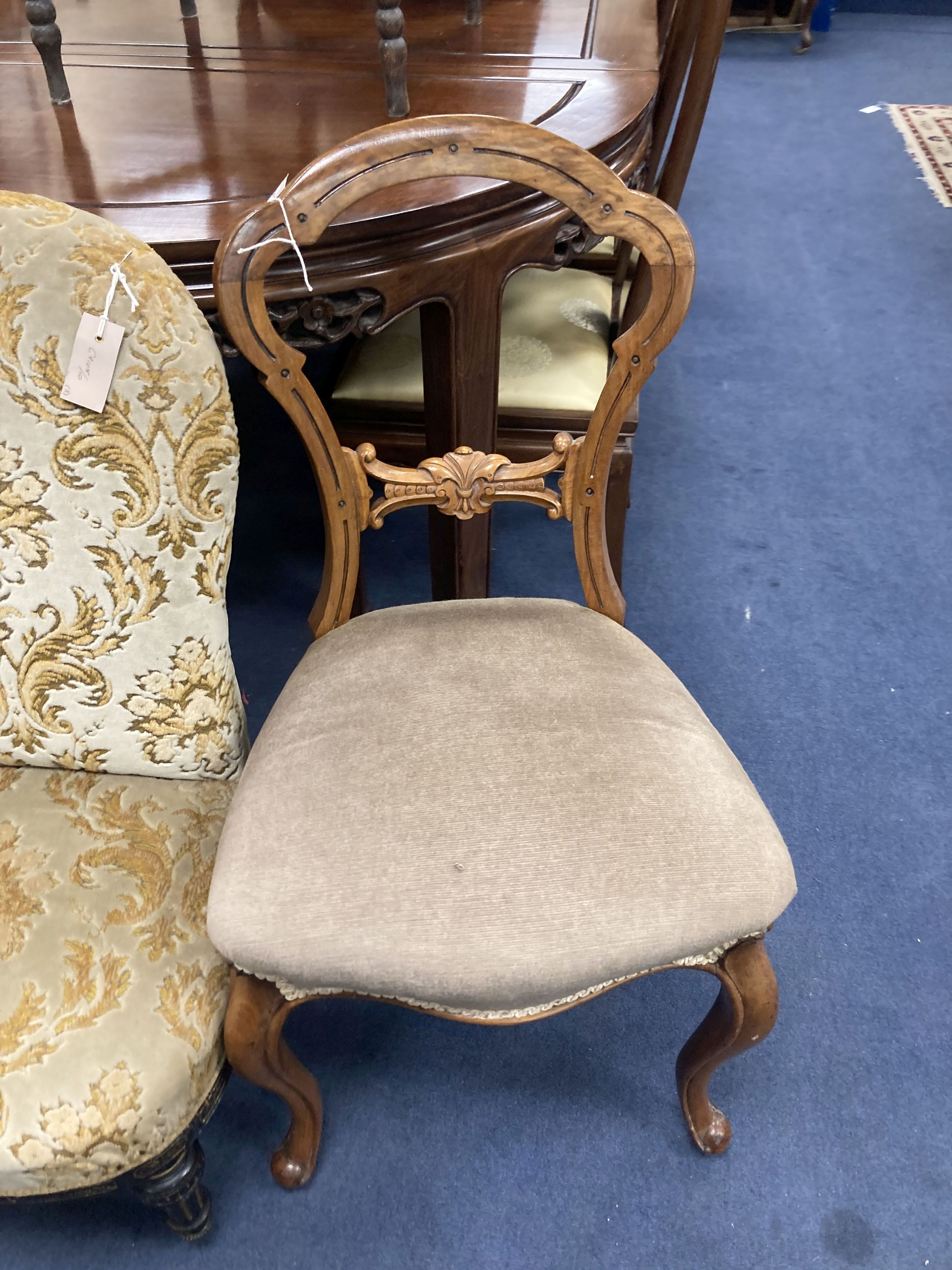 A Victorian ebonised and gilt upholstered nursing chair and pair of balloon back chairs